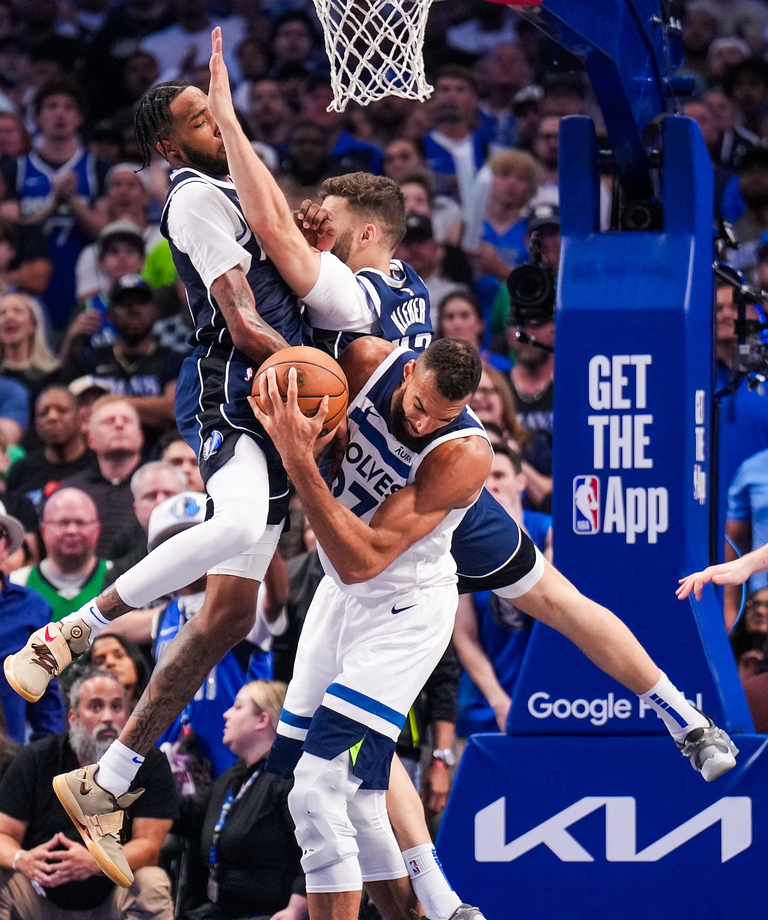 Minnesota Timberwolves center Rudy Gobert (27) is fouled as he is defended by Dallas...