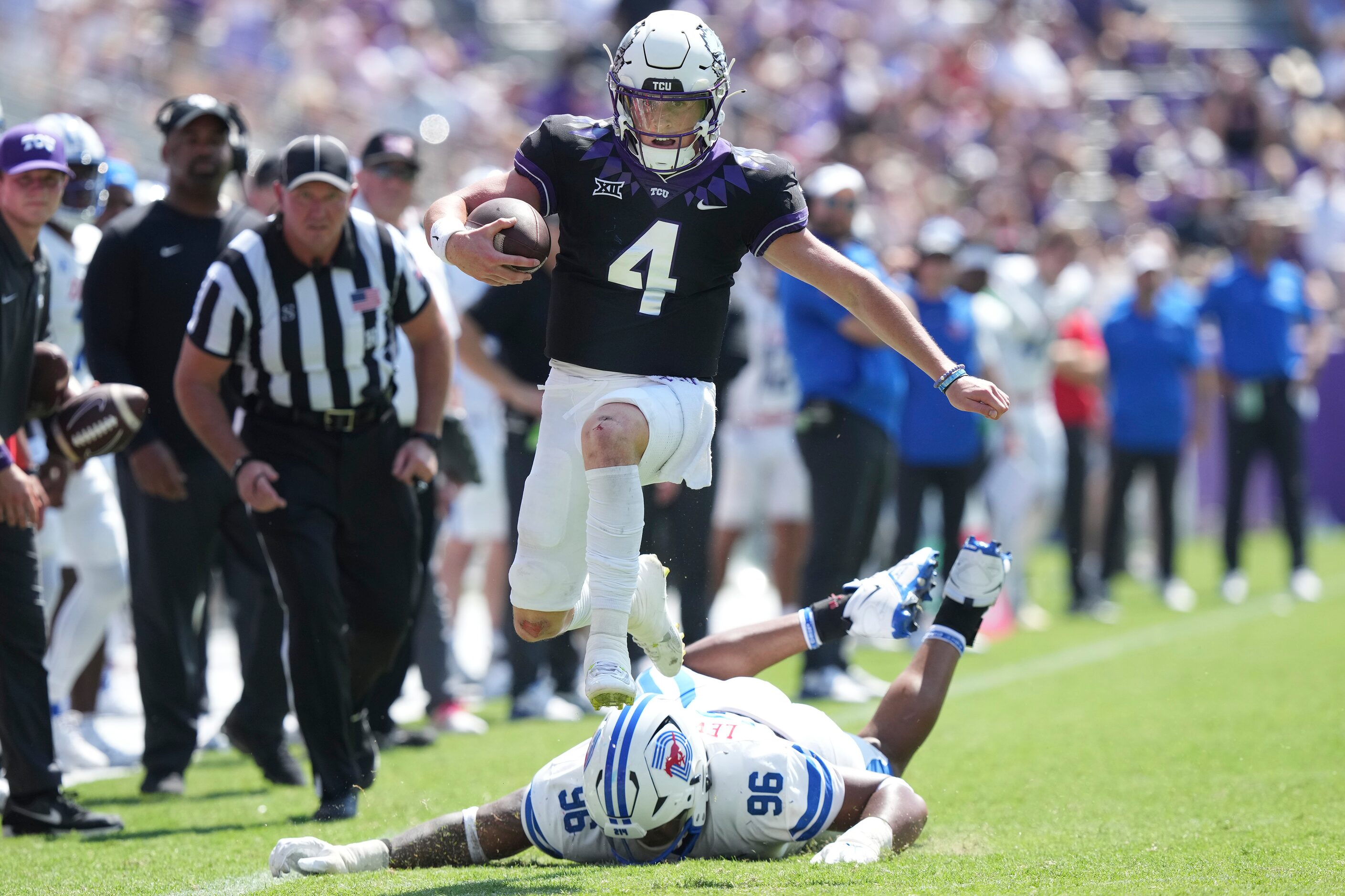 TCU quarterback Chandler Morris (4) jumps away from SMU defensive tackle DeVere Levelston...