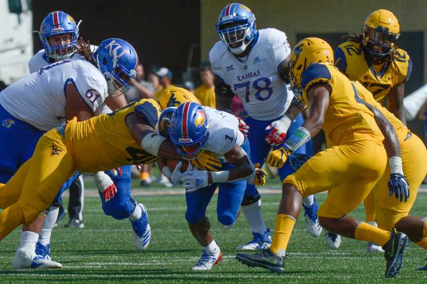 Kansas running back Pooka Williams Jr. (1) is tackled during the second half of an NCAA...