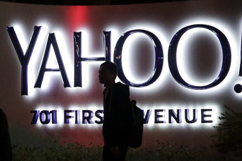 A passerby walks in front of a Yahoo sign at the company's headquarters in Sunnyvale, Calif....