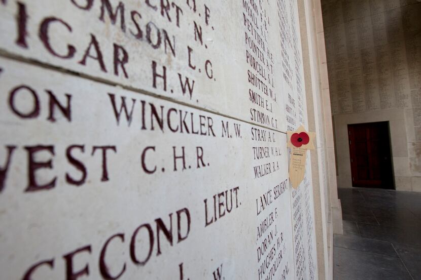 A wooden remembrance with a poppy is placed near names of the missing on the Menin Gate in...