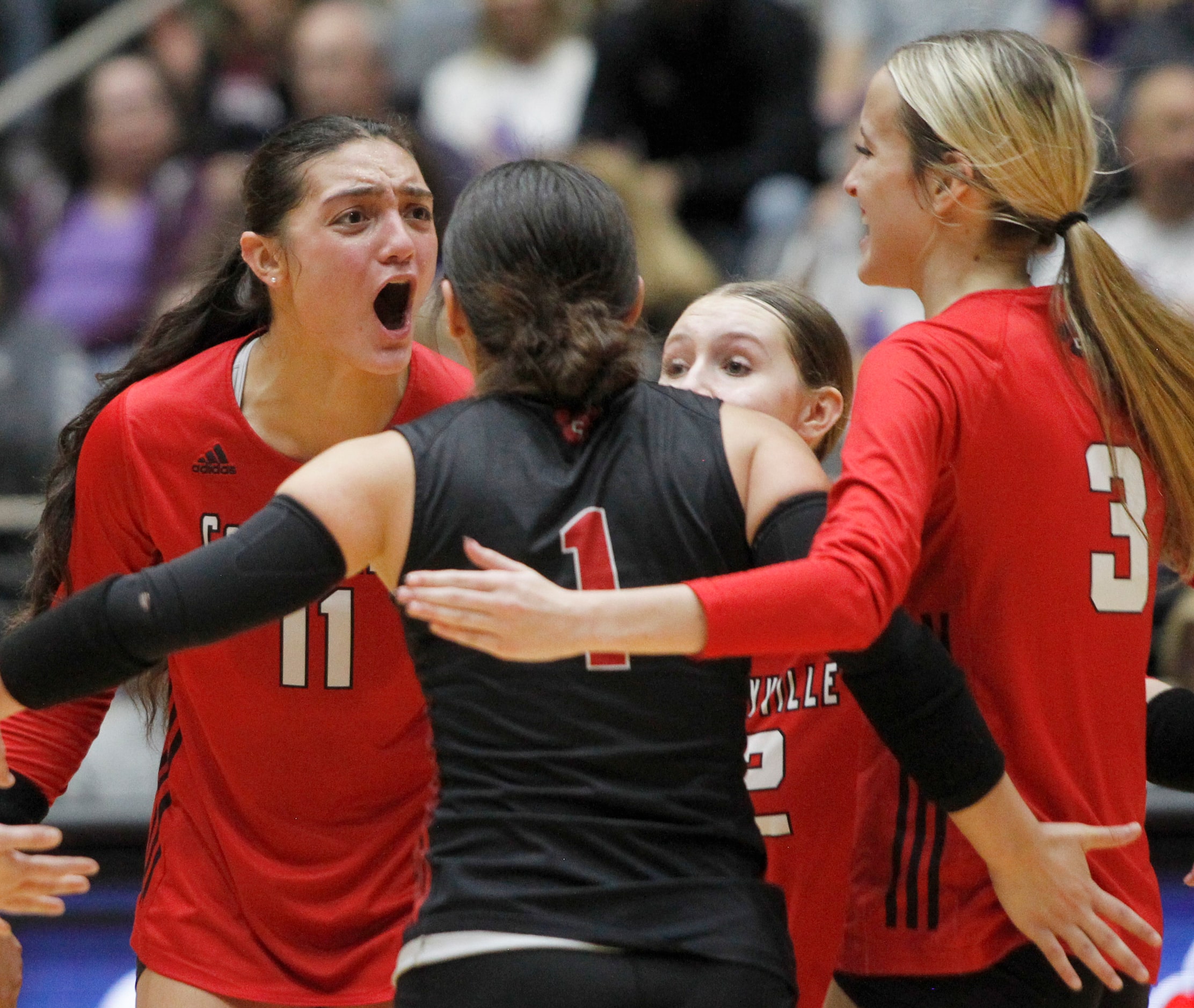 Colleyville Heritage junior Suli Davis (11), left, erupts after scoring in the 3rd set of...