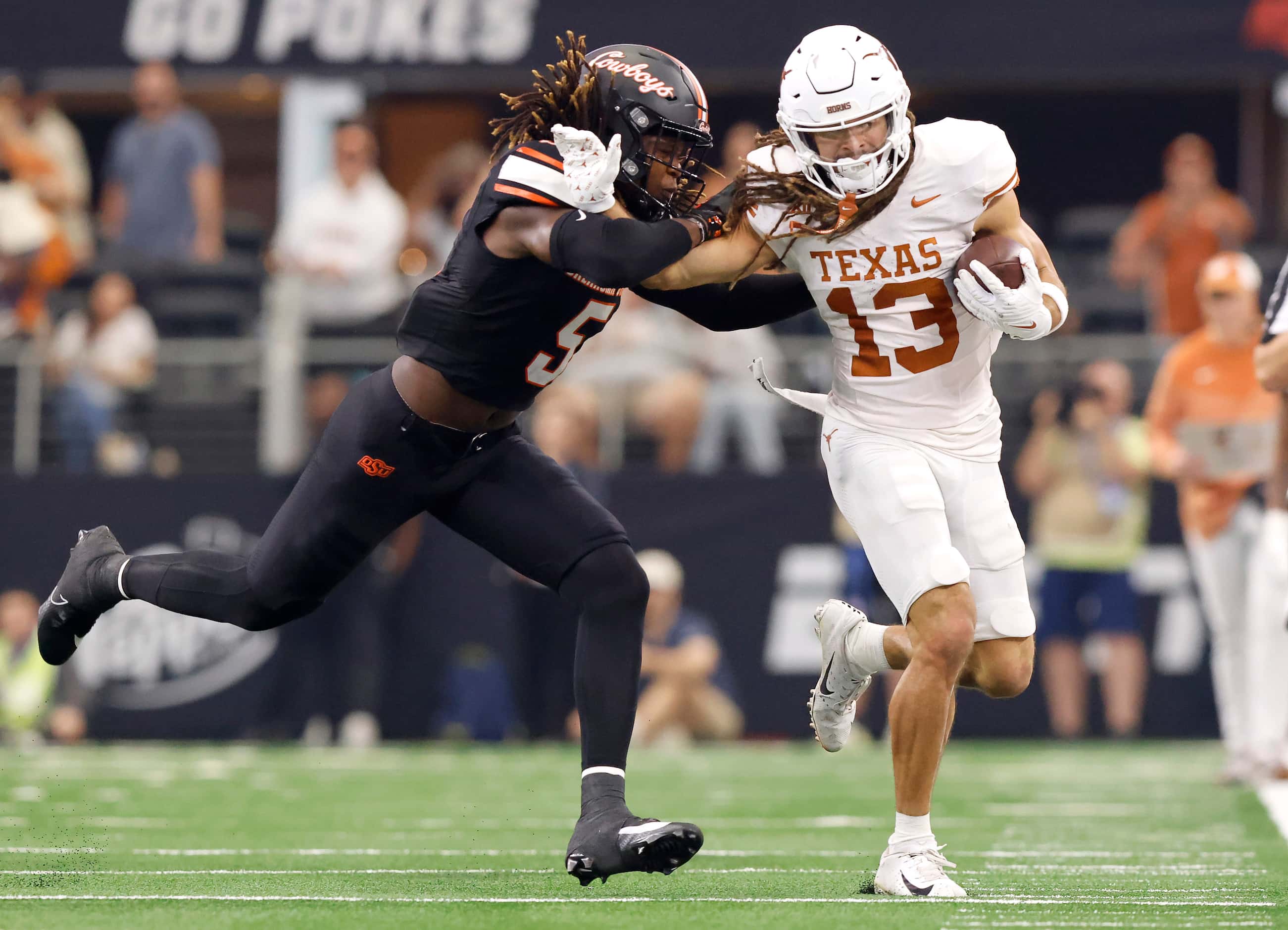 Texas Longhorns wide receiver Jordan Whittington (13) is forced out of bounds by Oklahoma...
