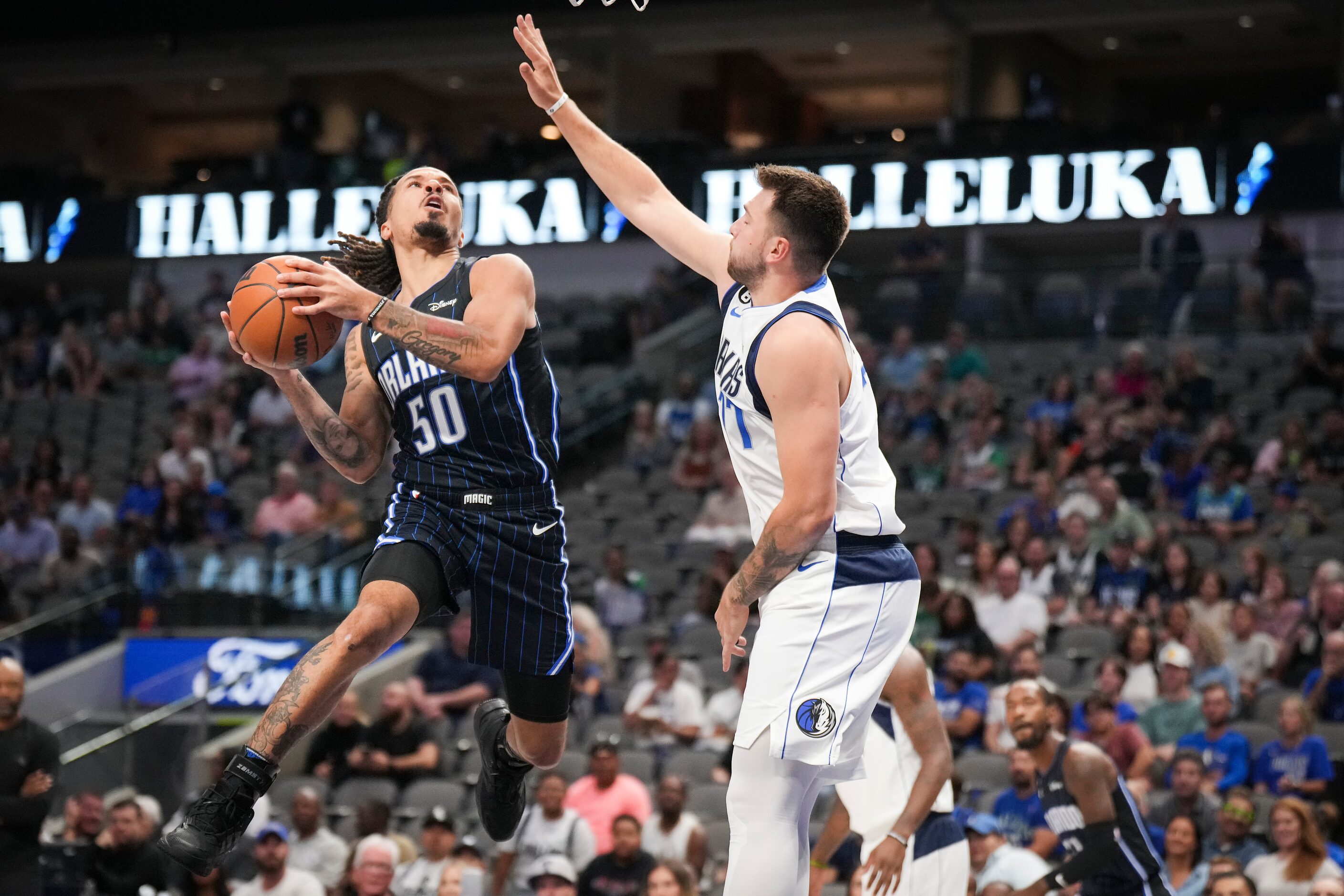 Dallas Mavericks guard Luka Doncic (77) defends against Orlando Magic guard Cole Anthony...