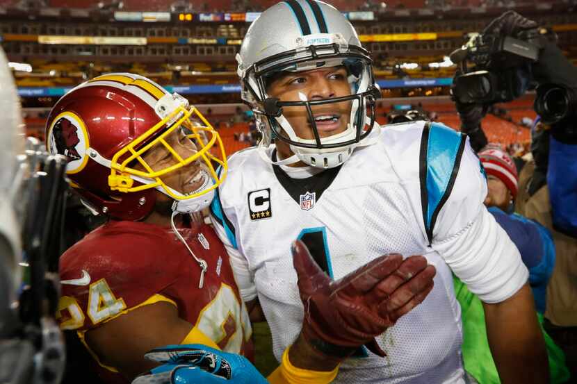 Washington Redskins cornerback Josh Norman (24) greets Carolina Panthers quarterback Cam...