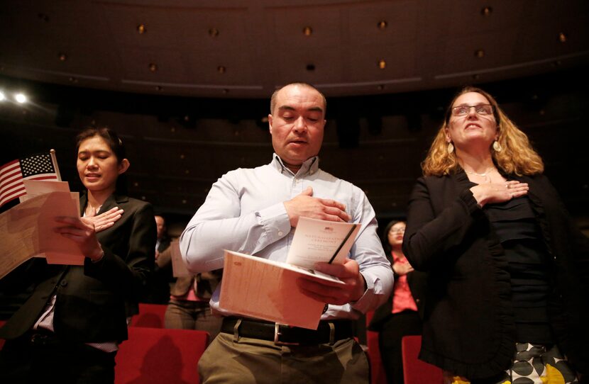 New U.S. citizens (from left) Supinya Phapant, of Thailand, Julio Martinez, of El Salvado,r...