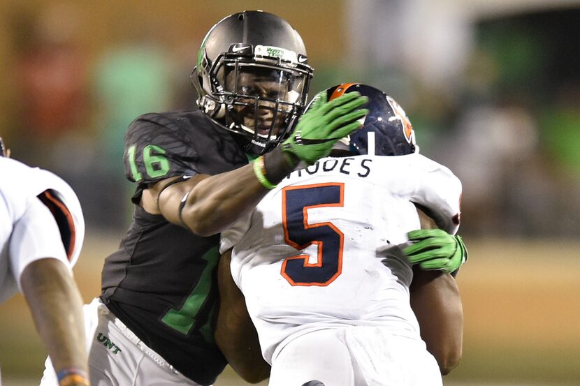 North Texas junior defensive back Kemon Hall (16) tackles Texas-San Antonio junior running...