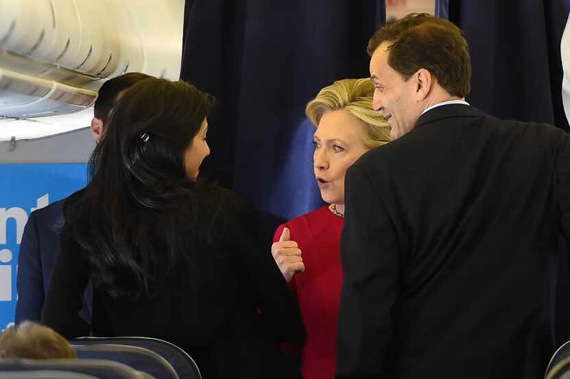 Democratic presidential nominee Hillary Clinton speaks with members of her staff aboard her...