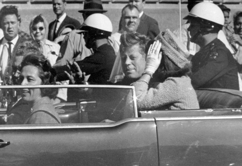 In this Nov. 22, 1963 file photo, President John F. Kennedy waves from his car in a...