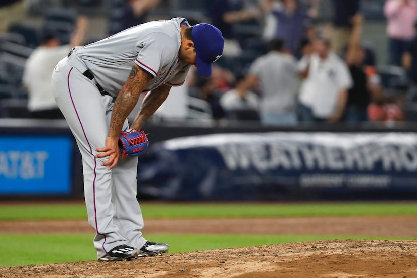 Texas Rangers pitcher Matt Bush reacts after giving up a solo home run to New York Yankees'...