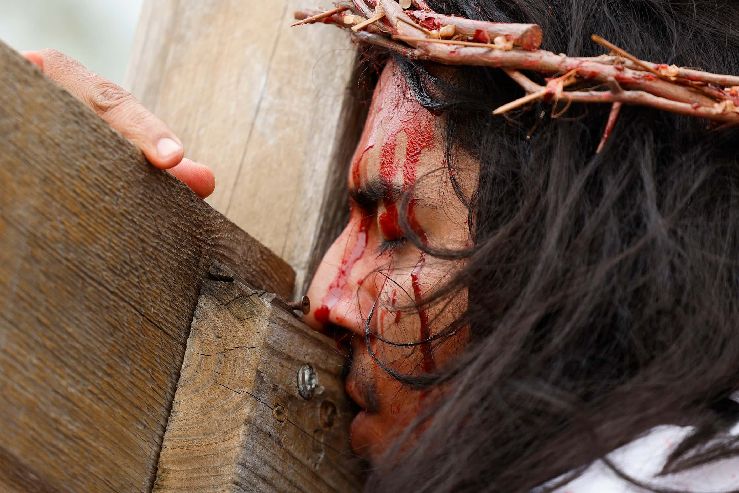 Bernie Gonzalez reenact the sufferings of Jesus Christ during Living Stations of the Cross...