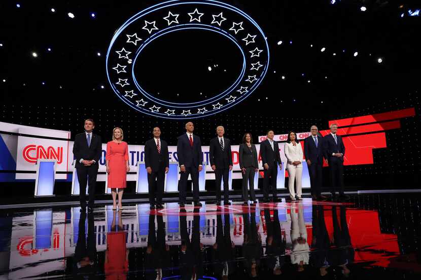 Joe Biden, shown at center left with rivals at the second debate in Detroit in July, leads...