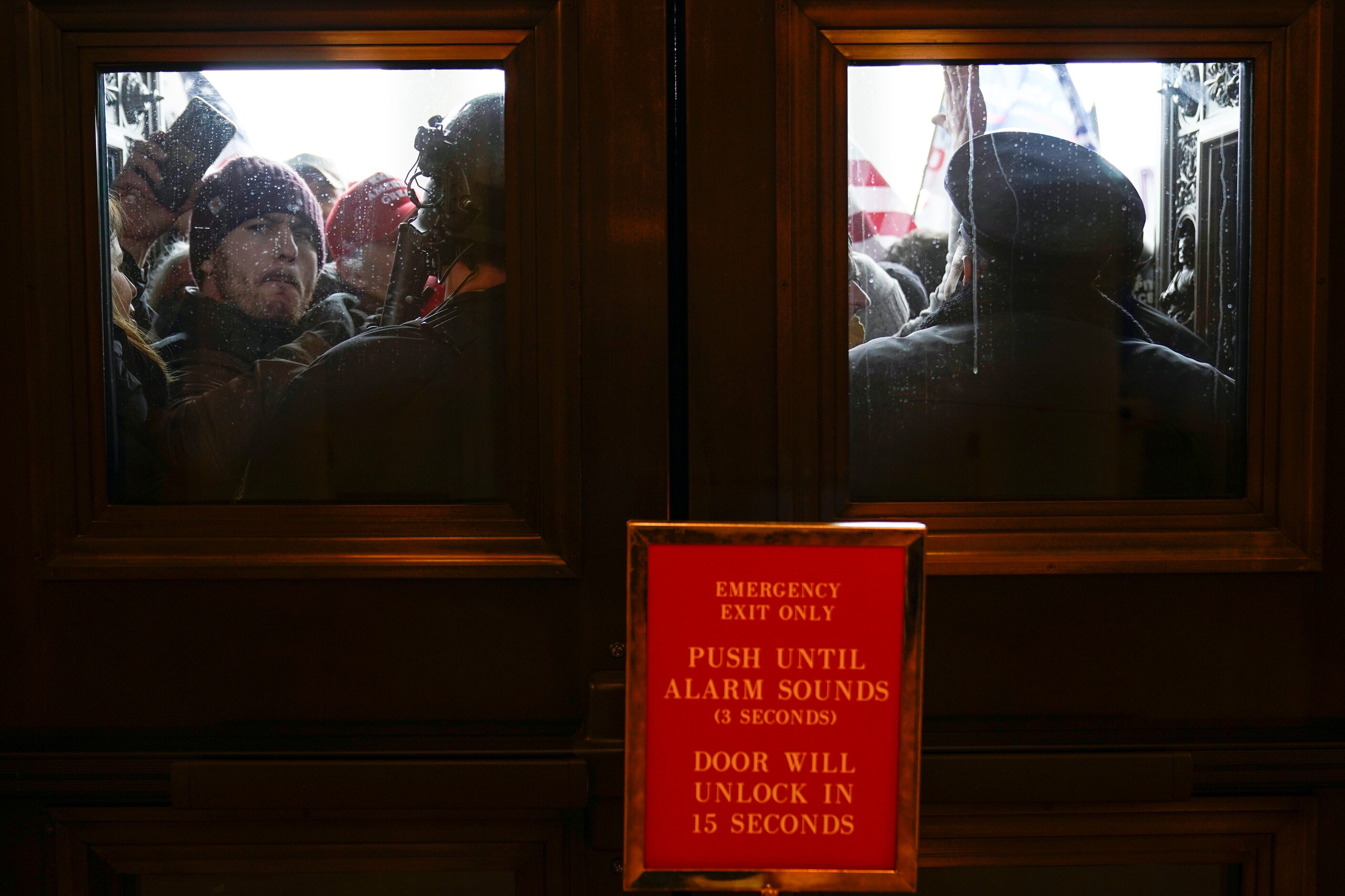 U.S. Capitol Police try to hold back protesters outside the east doors to the House side of...