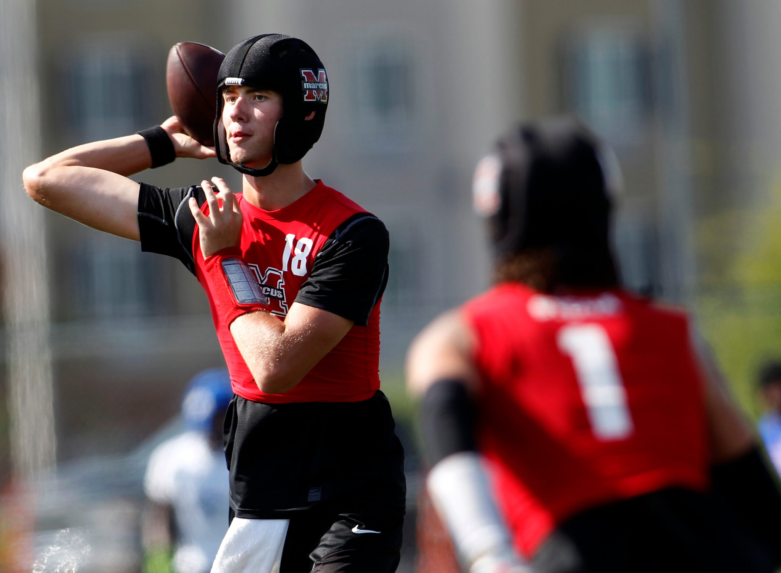 Flower Mound Marcus quarterback Cole Welliver (18) completes a short crossing route during...