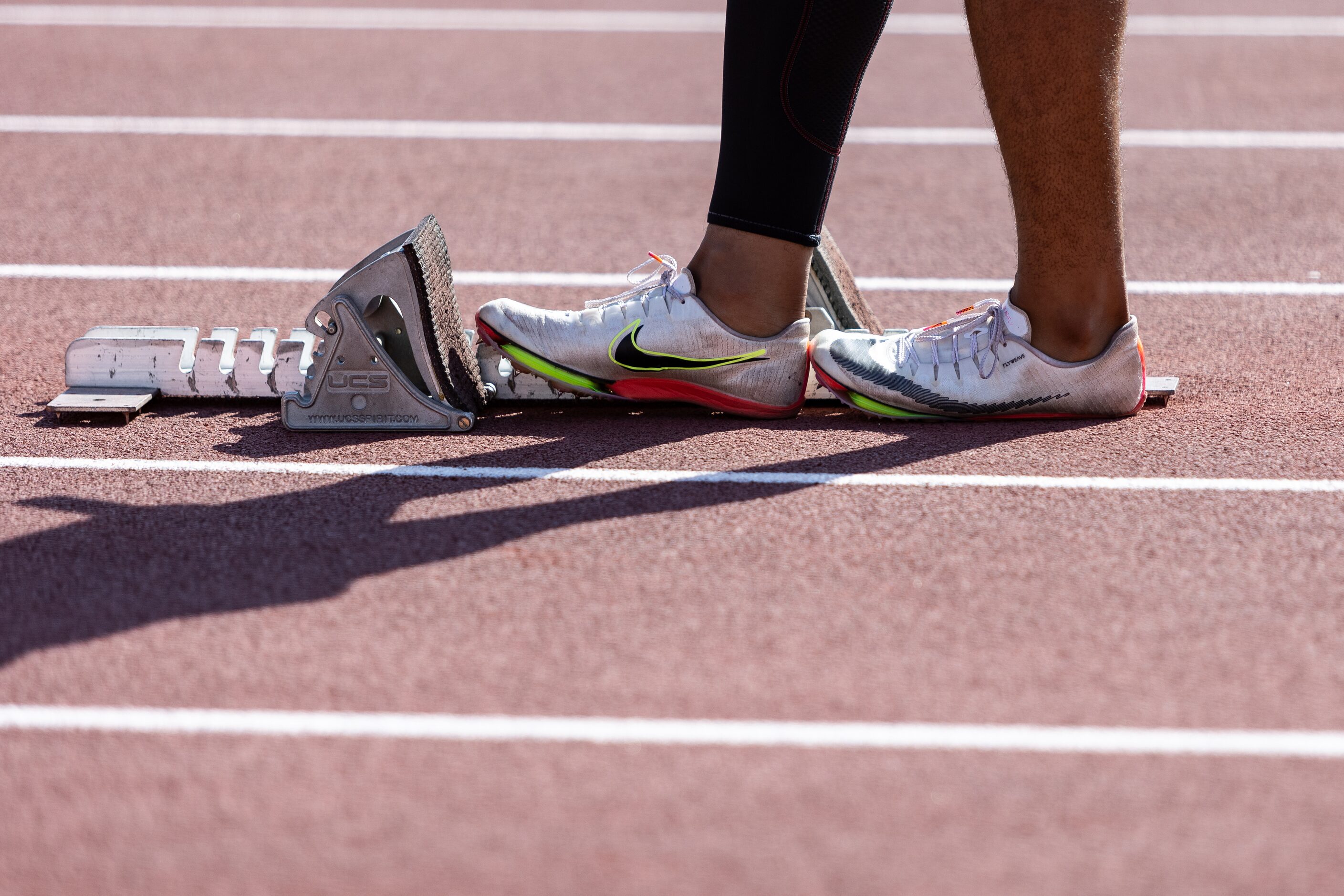 Caden Durham of Duncanville adjusts the starting blocks ahead of the boys' 4x100-meter relay...