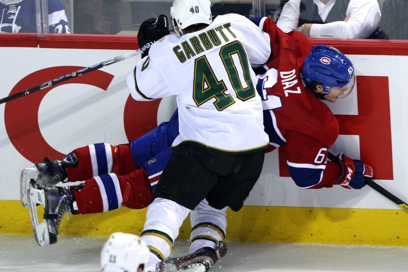 Dallas' Ryan Garbutt checks Montreal's Raphael Diaz into the boards during the first period...