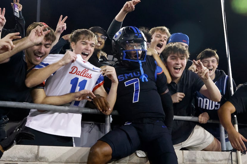 SMU quarterback Kevin Jennings (7) celebrates with fans after defeating Boston College in an...