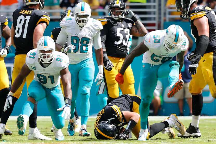 Miami Dolphins defensive end Cameron Wake (91) and defensive end Andre Branch (50) celebrate...