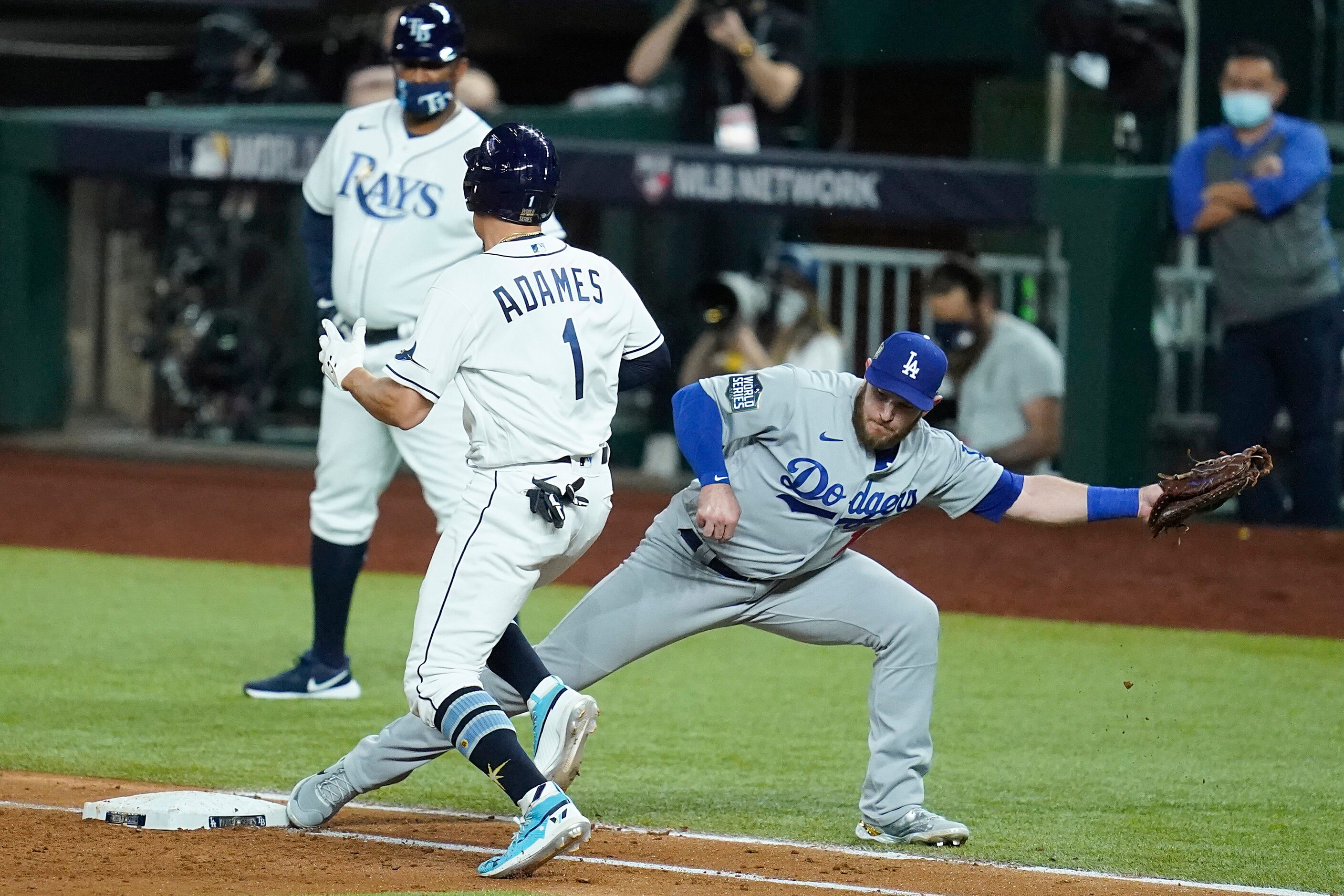 Los Angeles Dodgers first baseman Max Muncy stretches to make the play as Tampa Bay Rays...