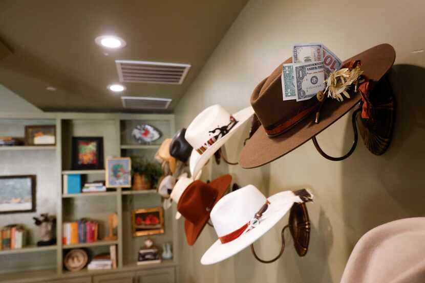 A cowboy hat collection at community-to-table restaurant Harvest is displayed on the...