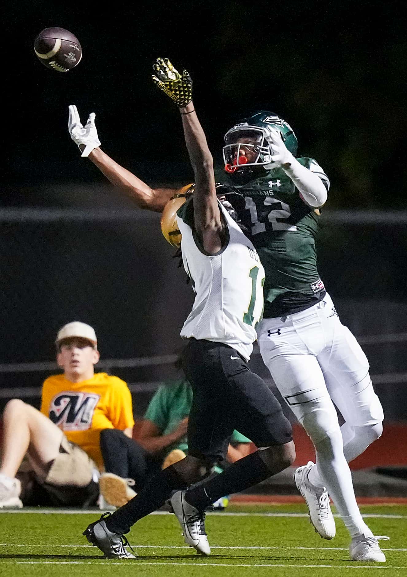 Waxahachie wide receiver Michael Esparza Jr. (12) tips the ball up and comes down with a...