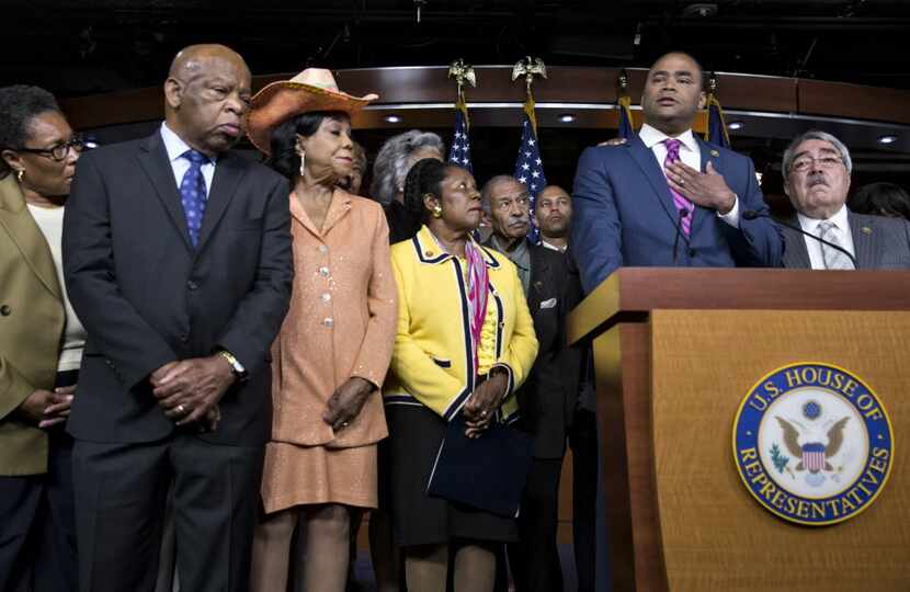 Rep. Marc Veasey, D-Texas, second from right, makes an emotional plea to end the violence...