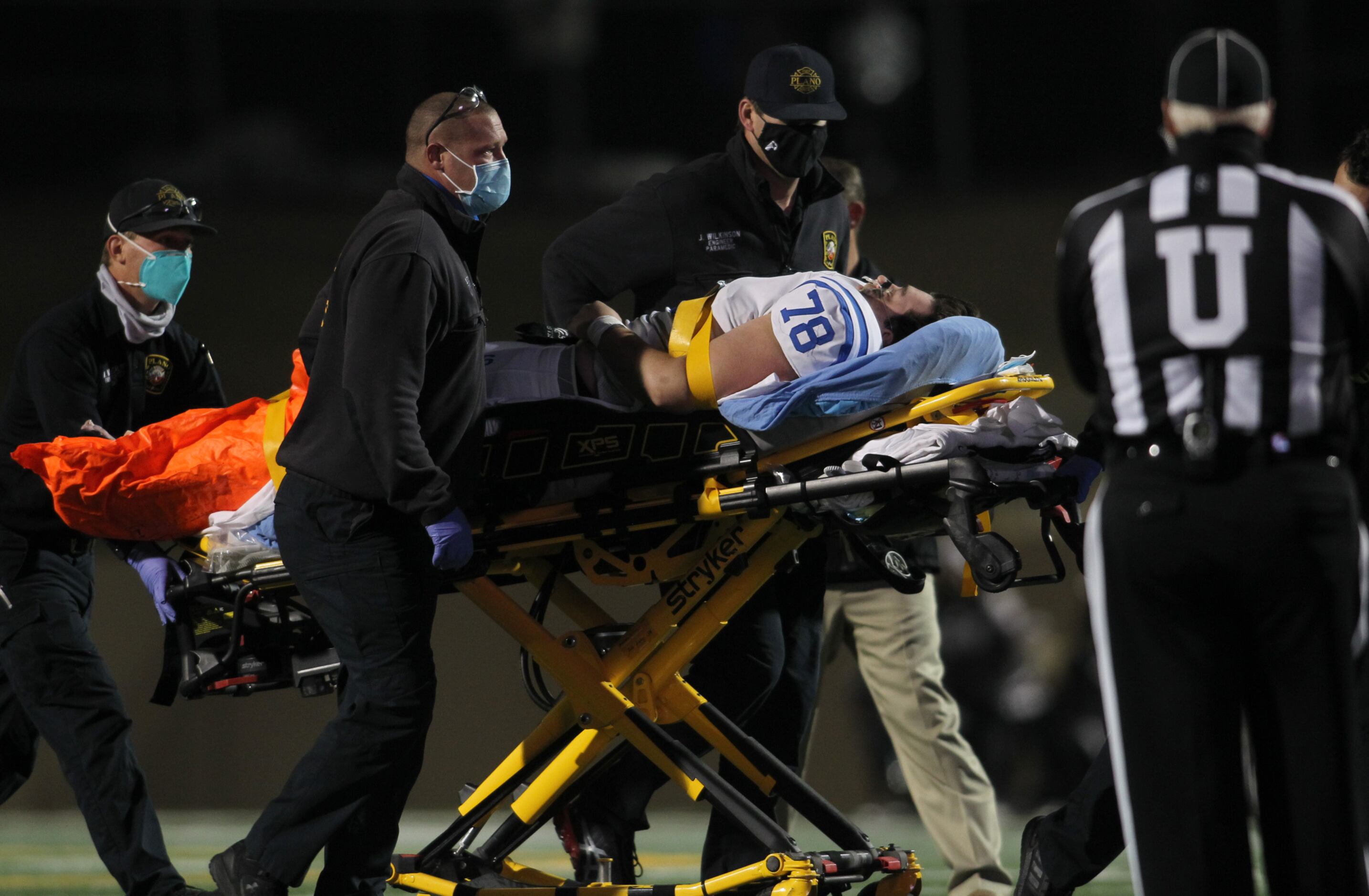 Plano fire personnel assist Plano West offensive lineman Carter Young (78) after he suffered...