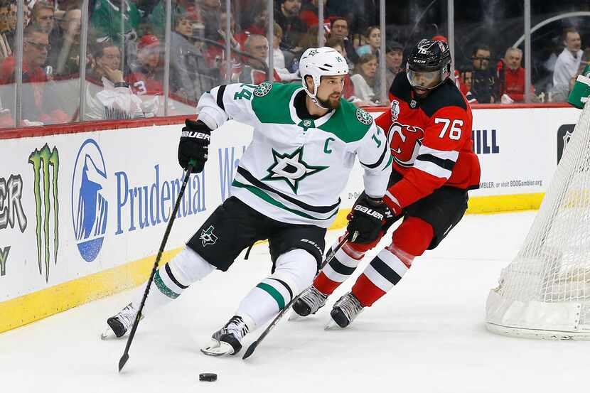 Dallas Stars left wing Jamie Benn (14) plays the puck against New Jersey Devils defenseman...