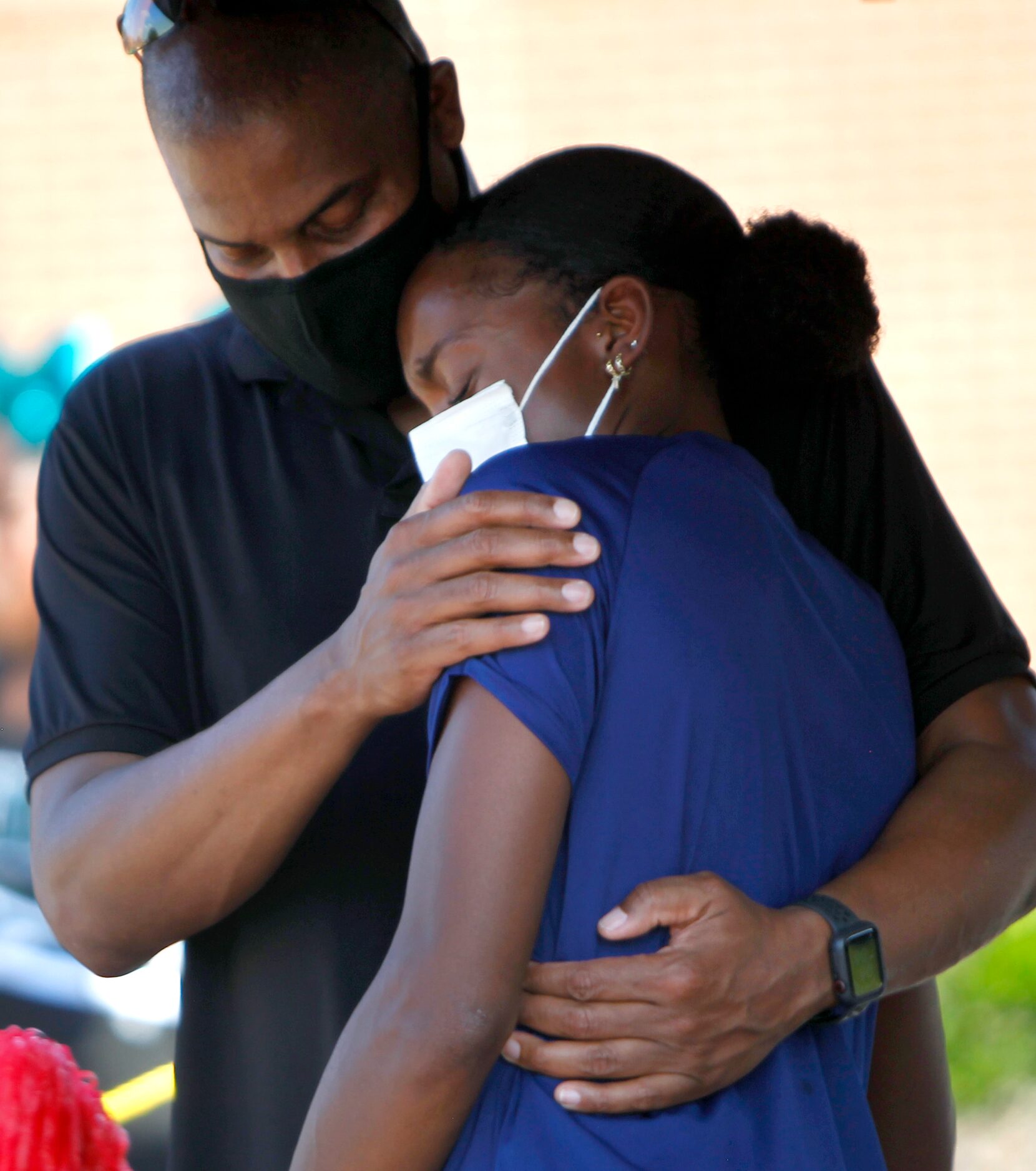 Jasmine Moore receives a hug from her dad Earl after delivering an emotional speech about...