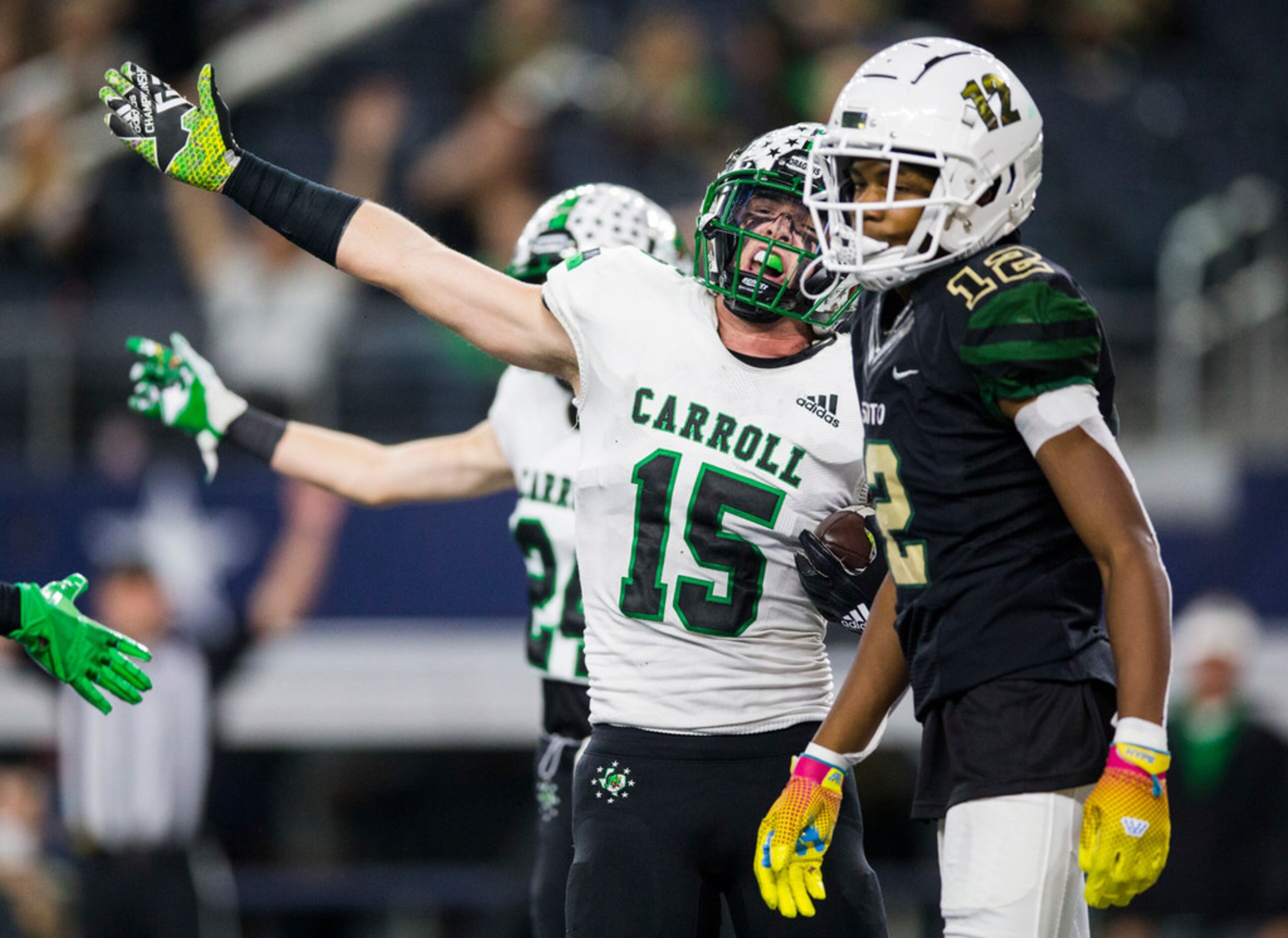 Southlake Carroll defensive back Brandon Howell (15) signals a turnover after he intercepted...