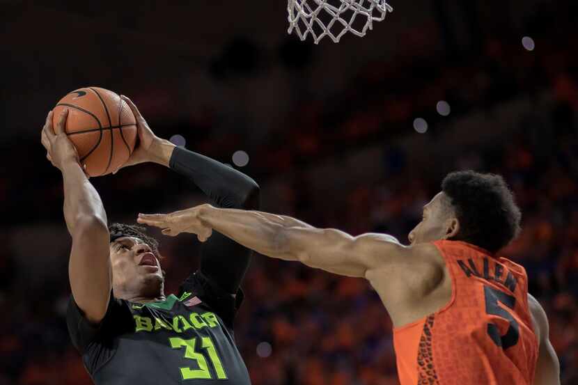 Florida guard KeVaughn Allen (5) puts a hand in the face to block Baylor forward Terry...