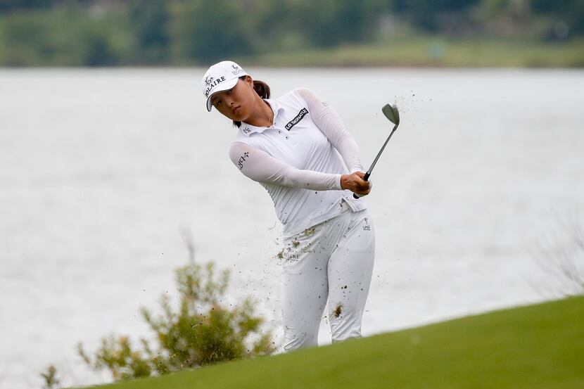 Professional golfer Jin Young Ko chips a ball onto the No. 14 green during the third round...
