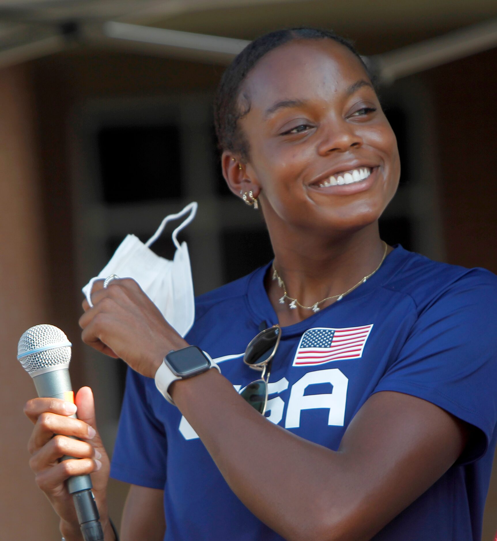 Jasmine Moore removes a facemark to expose a Texas-sized smile as she steps to the...