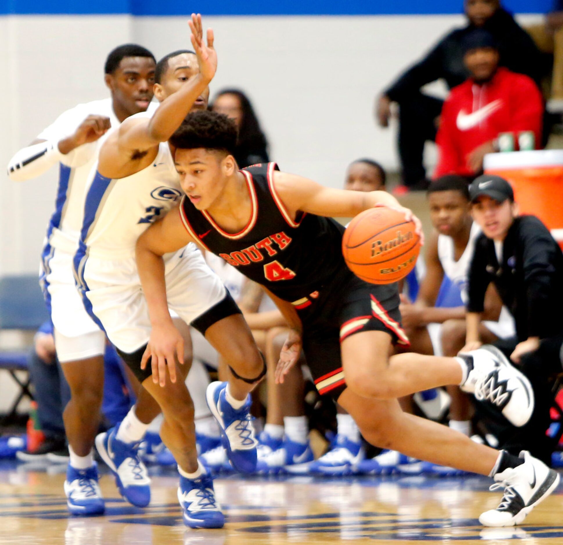 South Grand Prairie guard Khaden Bennett (4) drives against the aggressive defense of Grand...