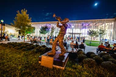 Visitors to the Coppell Arts Center sit around the statue "Amos" created by George Hensley.