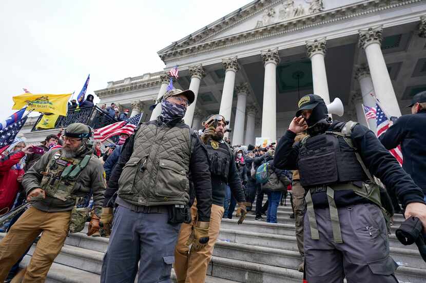FILE - Members of the Oath Keepers extremist group stand on the East Front of the U.S....