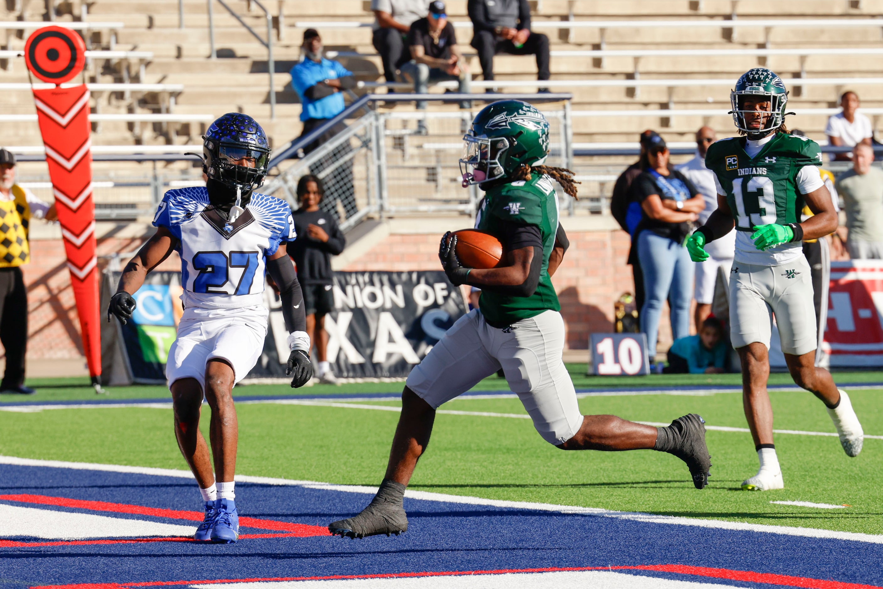 Waxahachie High’s Bryson Linnear (center) scores a touchdown against North Forney High...