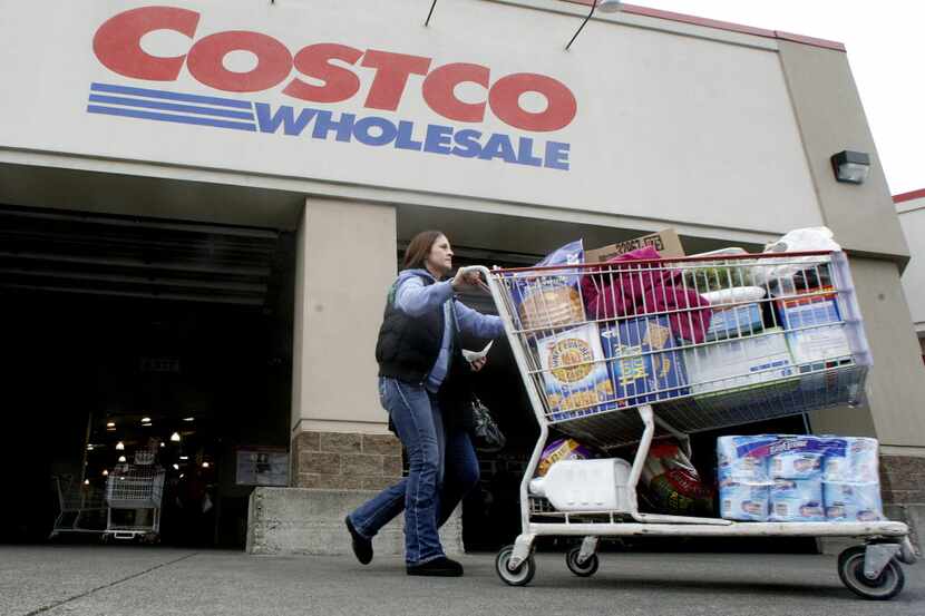 FILE- In this Wednesday, Dec. 7, 2011, file photo, a shopper leaves a Costco store in,...