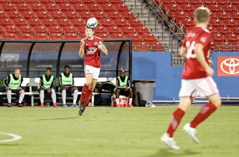 Captain Brecc Evans heads the ball upfield against Forward Madison in the North Texas SC...