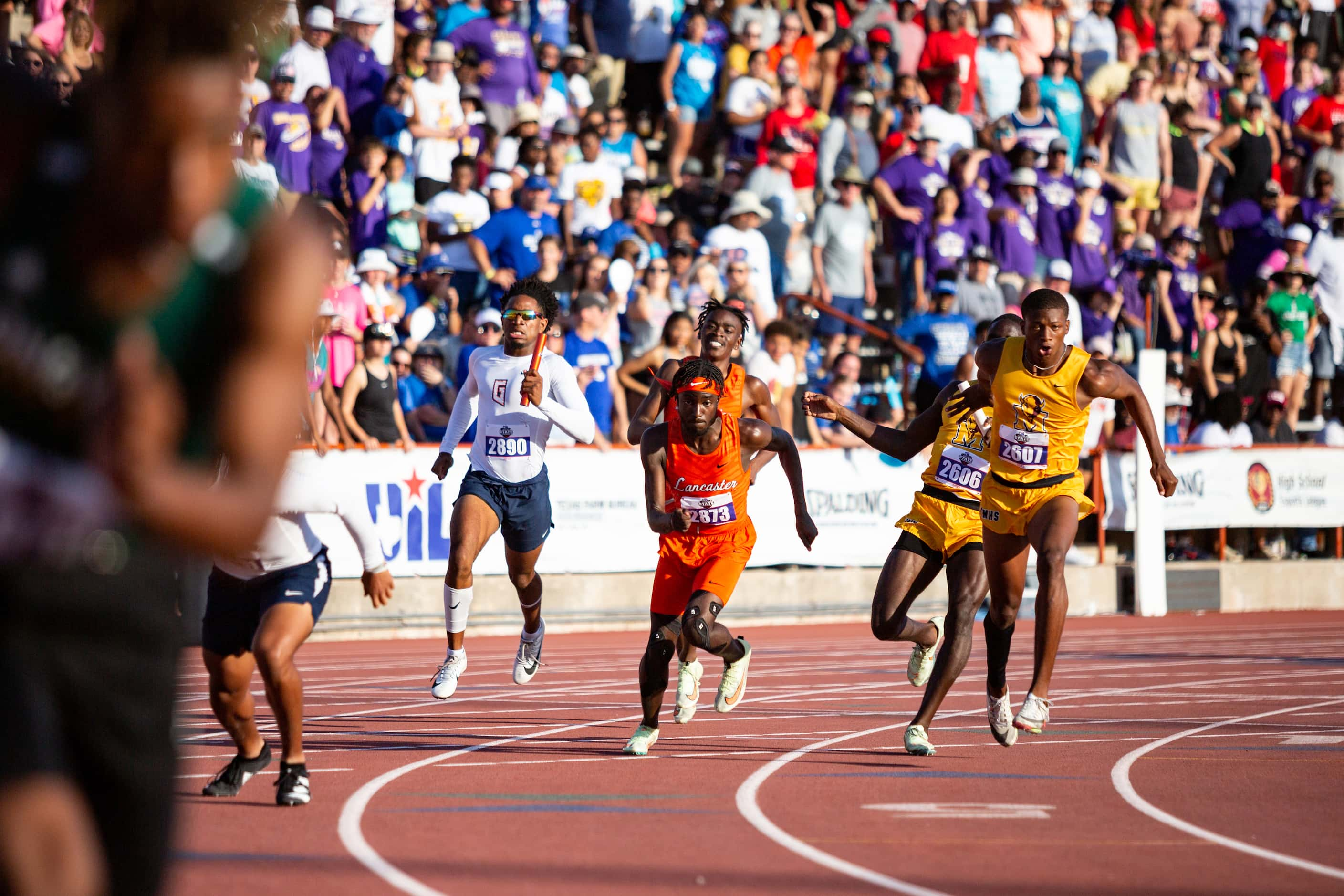 Lancaster’s Tomadric Jessie prepares to take the baton from Kordarion Smith during the boys’...