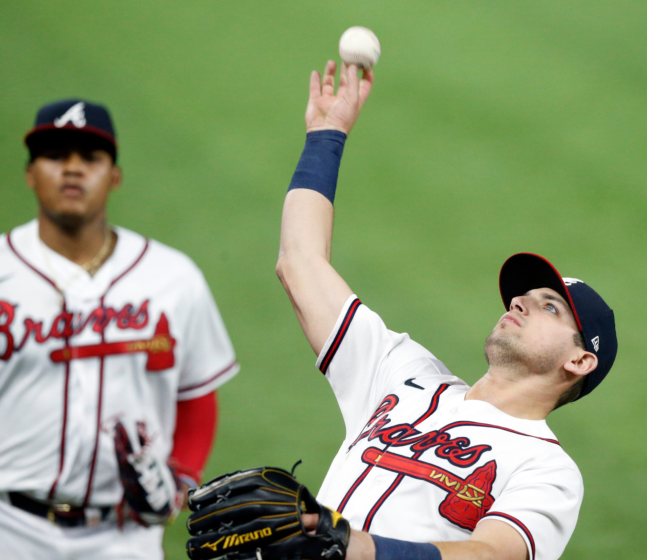 Atlanta Braves outfielder Austin Riley (27) tosses the last out to a fan in the stands as...