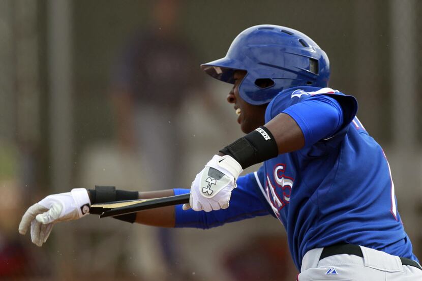 Prospect Jurickson Profar breaks his bat, but makes a hit during an intra-squad game during...