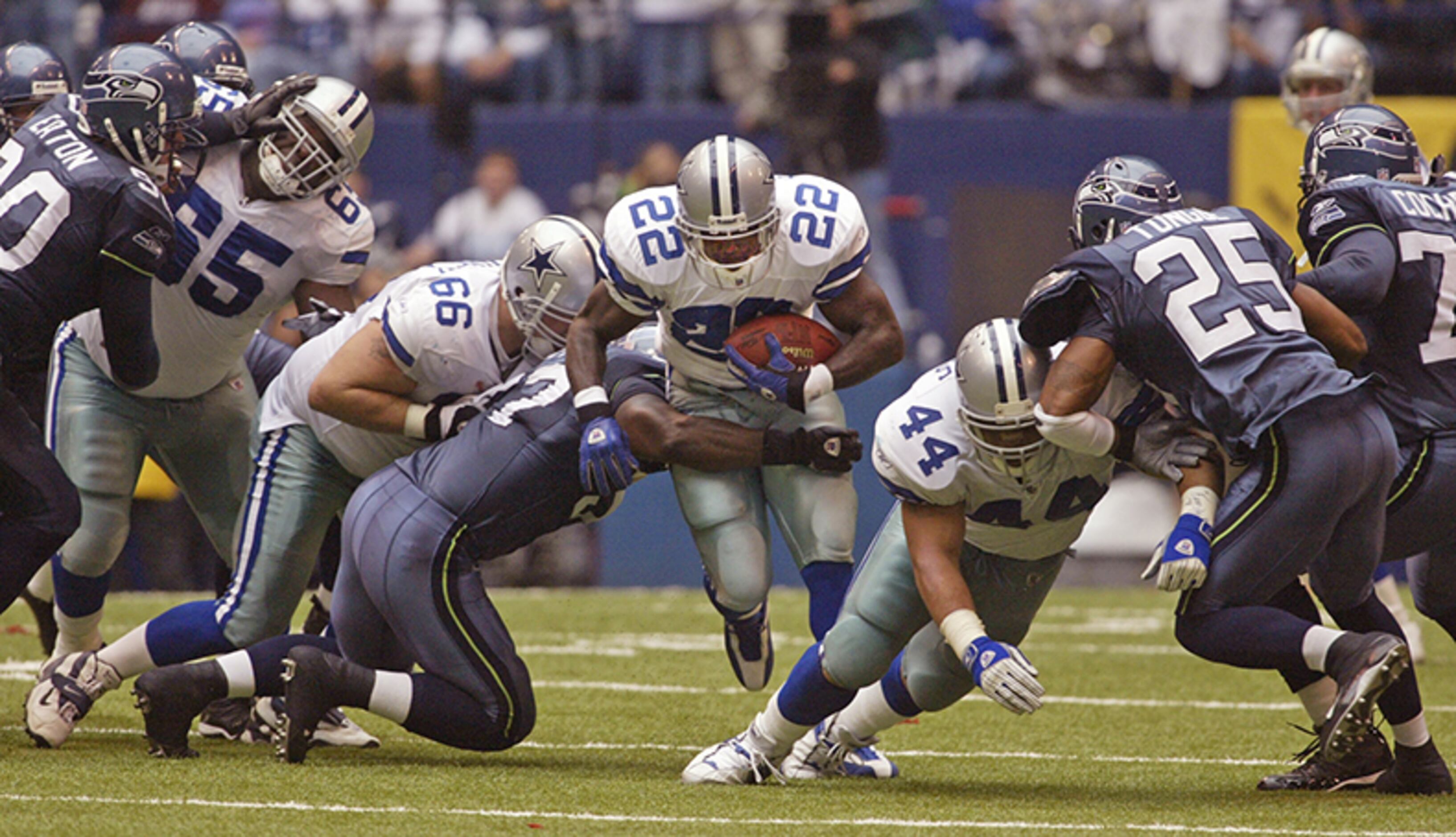 Running back Eddie George of the Dallas Cowboys attempts to break