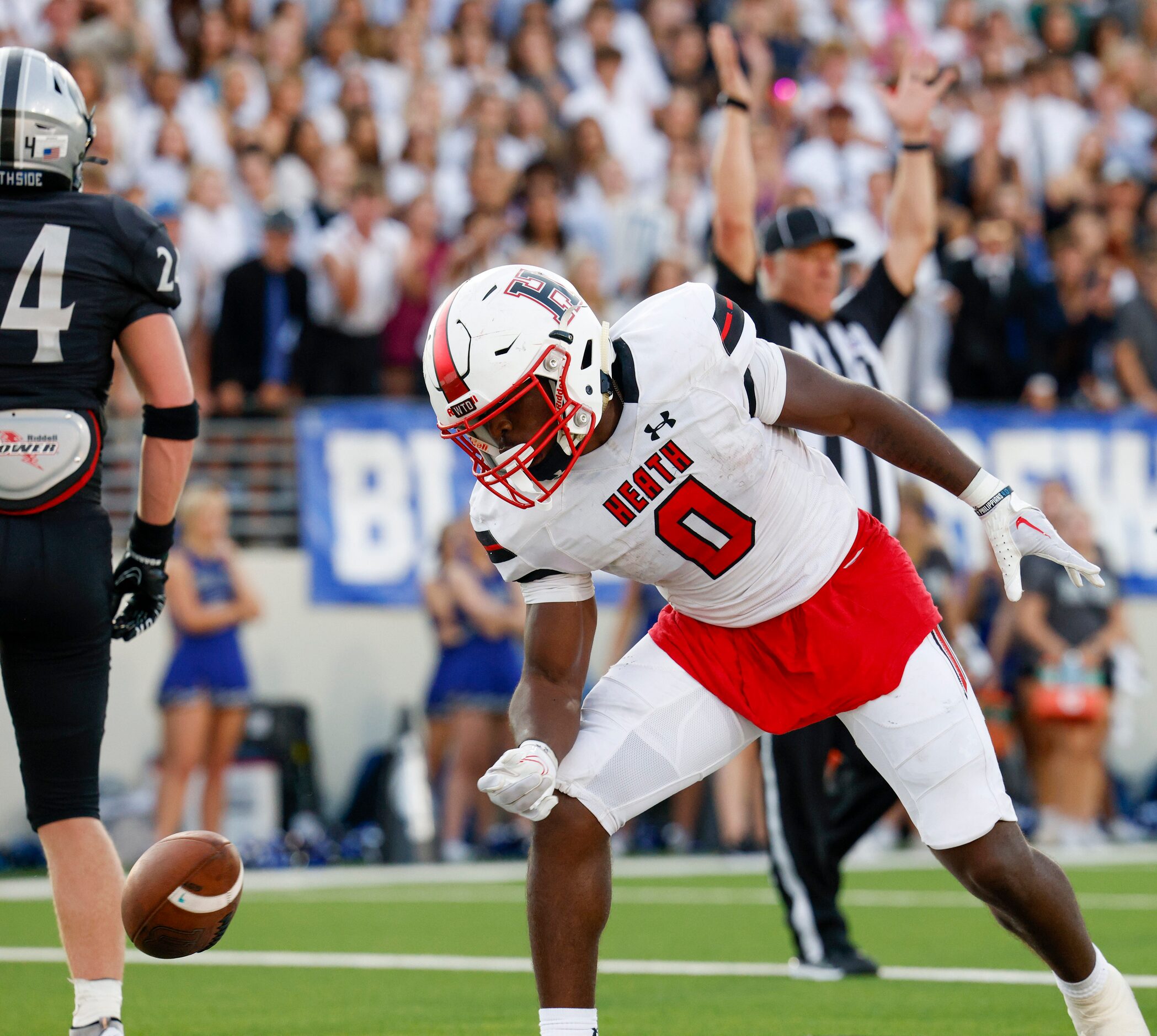 Rockwall-Heath running back Malachi Tuesno (0) flips the ball as he celebrates a touchdown...