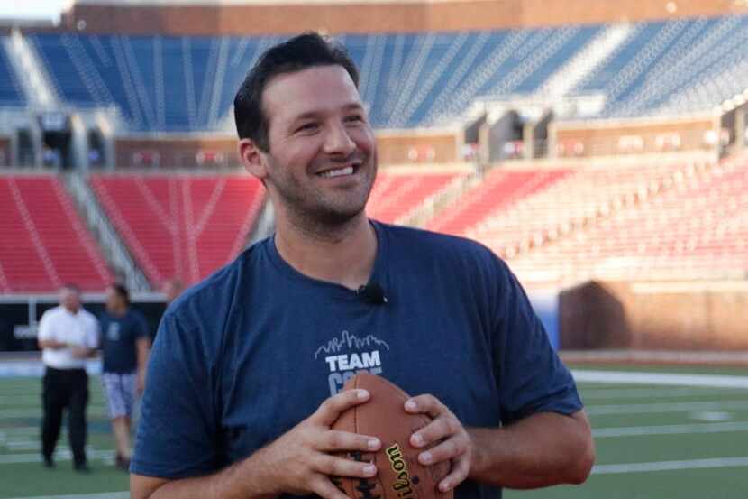 Tony Romo prepares to throw a pass to fans while they played jackpot during the Core Power...