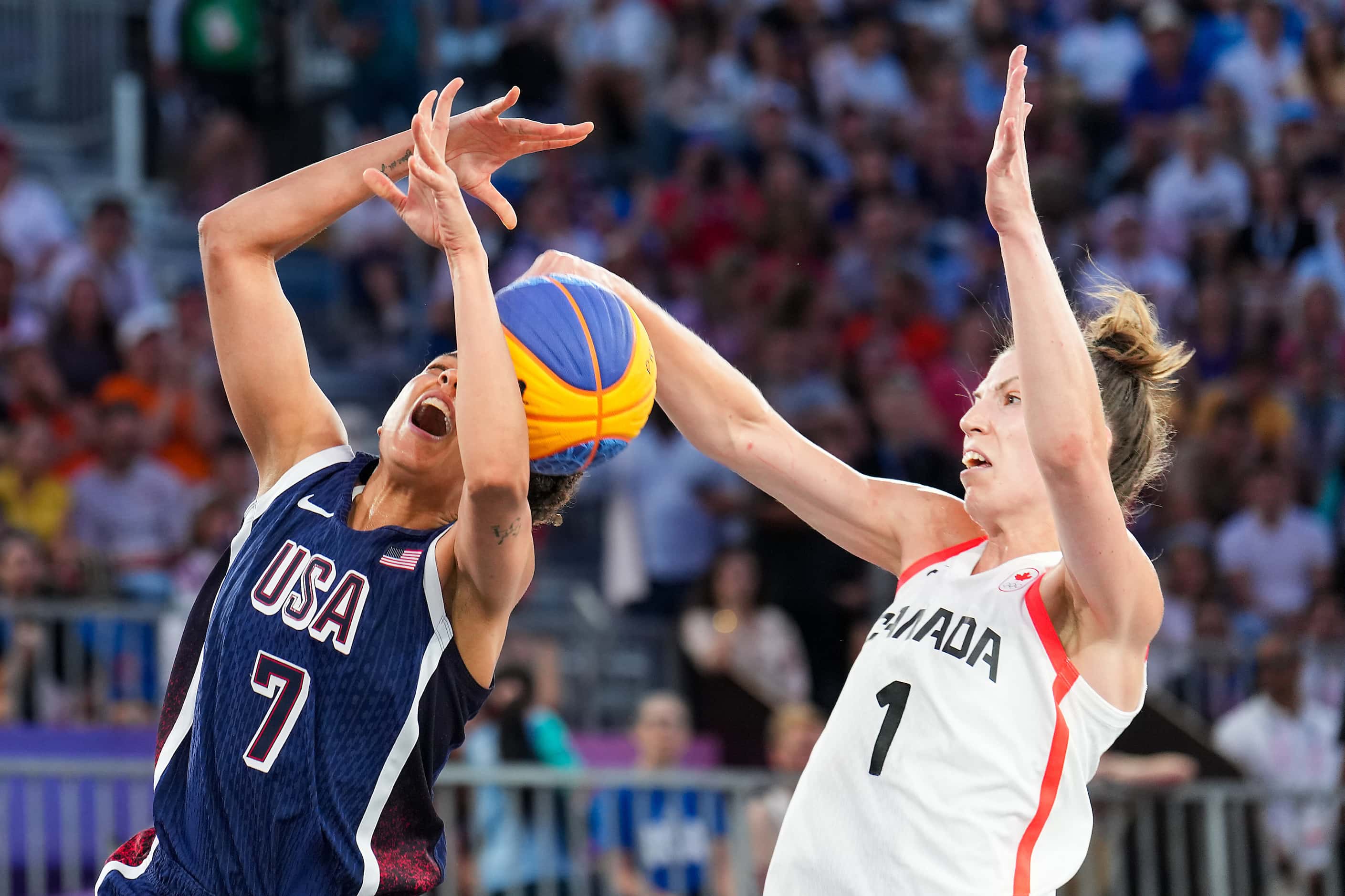 Cierra Burdick (7) of the United States is fouled by Canada’s Michelle Plouffe (1) during...