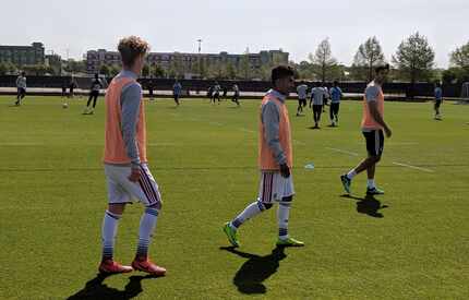 Chris Cappis (left) and Gibran Rayo (middle) walk alonside Ryan Hollingshead as their team...