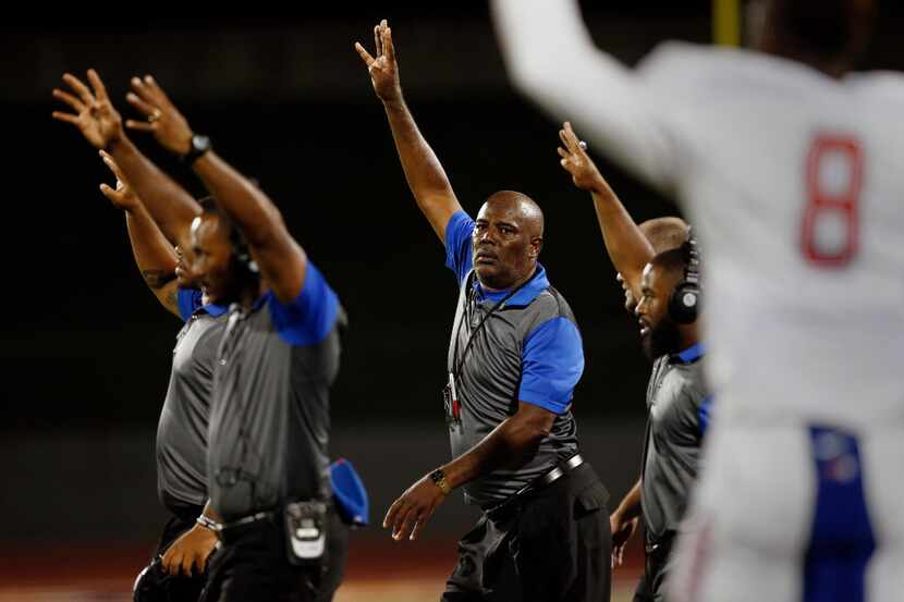 Duncanville head coach Reginald Samples, center, encourages his team going into the fourth...