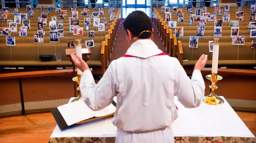 Father Clayton Elder rehearsed his Holy Thursday service in front of a sanctuary full of...