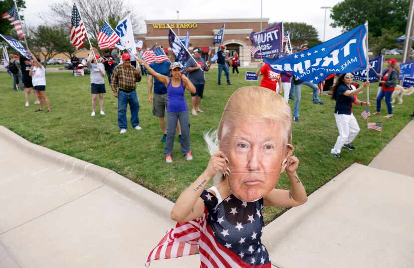 A supporter used a cutout of former President Donald Trump at a rally in Plano on April 4,...